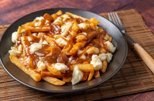 Poutine was originated in the... of Quebec, Canada